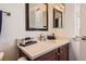 Bathroom featuring a vanity with sink, quartz countertop, modern fixtures, and decorative accents at 535 Elmhurst Way # A, Highlands Ranch, CO 80129