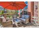 Relaxing patio area with comfortable seating under a large umbrella, perfect for outdoor enjoyment at 535 Elmhurst Way # A, Highlands Ranch, CO 80129