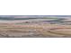 Expansive aerial view of farmland showing diverse textures, a rural landscape, and the layout of agricultural fields at 32350 E 137Th Way, Brighton, CO 80603