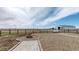 Expansive backyard features a brick patio with a fire pit, and a well-maintained gravel area at 32350 E 137Th Way, Brighton, CO 80603