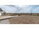 Backyard features a brick patio with a fire pit, and a well-maintained gravel area at 32350 E 137Th Way, Brighton, CO 80603