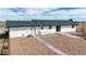 Exterior of home features a brick patio and landscaped gravel area at 32350 E 137Th Way, Brighton, CO 80603