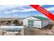 Spacious barn with white exterior, green roof, and large doors, offering versatile space at 32350 E 137Th Way, Brighton, CO 80603