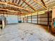 Bright barn interior with concrete floors, metal siding, and an open ceiling, offering a versatile space for various uses at 32350 E 137Th Way, Brighton, CO 80603