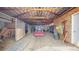 Interior of a barn showing horse stalls, a tractor, and equipment at 32350 E 137Th Way, Brighton, CO 80603