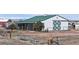 View of a large white barn with a green roof on an expansive rural property at 32350 E 137Th Way, Brighton, CO 80603