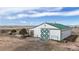 Aerial view of barn with a large open sliding door, showcasing its ample space at 32350 E 137Th Way, Brighton, CO 80603