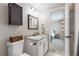 A well-lit bathroom features granite counters, a dark vanity and a view into the connecting bedroom at 32350 E 137Th Way, Brighton, CO 80603