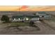 Exterior shot of the home at sunset with great views of the surrounding landscape at 32350 E 137Th Way, Brighton, CO 80603