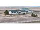 Charming exterior view of a white house with green roof and landscaping at 32350 E 137Th Way, Brighton, CO 80603