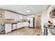 A modern kitchen featuring white cabinets, stainless steel appliances, and granite countertops with wood-look floors at 32350 E 137Th Way, Brighton, CO 80603