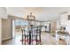 Bright kitchen with stainless steel appliances, white cabinets, and a modern light fixture over a glass-top table at 32350 E 137Th Way, Brighton, CO 80603