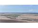Wide aerial view of fields stretching to distant mountains, showcasing the property's scenic beauty and natural surroundings at 32350 E 137Th Way, Brighton, CO 80603