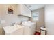 Laundry room with white washer, dryer, sink, and cabinets at 32350 E 137Th Way, Brighton, CO 80603
