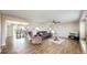 Cozy living room featuring wood floors, comfortable seating, and a ceiling fan at 32350 E 137Th Way, Brighton, CO 80603