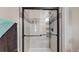 Modern bathroom shower with sleek glass doors, tiled walls, and built-in shelving for a spa-like experience at 32350 E 137Th Way, Brighton, CO 80603