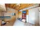 Small storage room in the barn with plywood walls and a painted concrete floor at 32350 E 137Th Way, Brighton, CO 80603