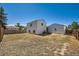 Spacious backyard with a well-maintained lawn, a fence, and an attached garage for convenience at 4600 Dillon St, Denver, CO 80239