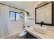Chic bathroom with modern fixtures including a new vanity, rainfall shower and hexagon tile at 4600 Dillon St, Denver, CO 80239