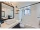 Modern bathroom featuring a sleek vanity, floating shelves, and shower-tub combination at 4600 Dillon St, Denver, CO 80239