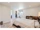 Bright bedroom with wood floors has room for a desk or sitting area and ensuite bath at 4600 Dillon St, Denver, CO 80239