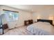 Bright bedroom with hardwood floors, a writing desk, and a large window at 4600 Dillon St, Denver, CO 80239