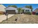 Charming single-story home with a well-maintained lawn and a two-car garage with an extended driveway at 4600 Dillon St, Denver, CO 80239