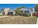 Inviting single-story home with a two-car garage, tidy landscaping, and a cozy front porch at 4600 Dillon St, Denver, CO 80239