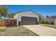 Attached garage providing convenience and security with its durable design and additional parking at 4600 Dillon St, Denver, CO 80239
