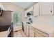 Modern kitchen features white cabinetry, countertops, and a stainless steel refrigerator at 4600 Dillon St, Denver, CO 80239