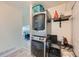 Convenient laundry area with stacked washer and dryer and shelving for storage at 4600 Dillon St, Denver, CO 80239