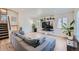 Spacious living room featuring modern decor, light wood floors, and abundant natural light at 4600 Dillon St, Denver, CO 80239