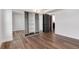 Bedroom with hardwood floors, mirrored closet doors, and a modern dark door at 2 Adams St # 1504, Denver, CO 80206