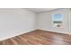 Bright bedroom features a large window with city views and wood-look flooring at 2 Adams St # 1504, Denver, CO 80206