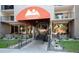 Welcoming entrance to Mountain Shadows Condominiums featuring well-maintained landscaping at 2 Adams St # 1504, Denver, CO 80206