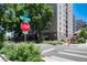 Mountain Shadows Condominiums building with street signs, greenery, and a crosswalk on a sunny day at 2 Adams St # 1504, Denver, CO 80206