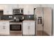 Close-up showcasing the stainless steel oven, refrigerator, microwave, and white cabinets at 2 Adams St # 1504, Denver, CO 80206