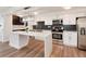 Newly renovated kitchen with a waterfall island, stainless appliances, and modern light fixtures at 2 Adams St # 1504, Denver, CO 80206