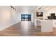 Bright living room with hardwood floors, balcony access, and an open layout to the kitchen at 2 Adams St # 1504, Denver, CO 80206