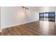 Bright living room features wood-look flooring, neutral paint, and city views at 2 Adams St # 1504, Denver, CO 80206