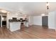 Wide angle view showing the open-concept layout, hardwood floors, and modern kitchen amenities at 2 Adams St # 1504, Denver, CO 80206