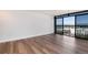 Bright living room featuring wood-look flooring, neutral paint, and city views at 2 Adams St # 1504, Denver, CO 80206