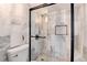 Shower with marble walls, glass doors and black hardware at 2 Adams St # 1504, Denver, CO 80206