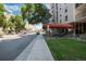 Street view of the condo building, featuring sidewalk, street, and partial view of the building at 2 Adams St # 1504, Denver, CO 80206
