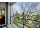 Relaxing balcony with modern railing overlooks a beautifully landscaped outdoor area at 2958 Syracuse St # 204, Denver, CO 80238