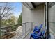 Relaxing balcony with blue chairs and view of green foliage at 2958 Syracuse St # 204, Denver, CO 80238