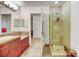 Bathroom featuring a shower, tile flooring, cherry vanity with plenty of counter space and recessed lighting at 2958 Syracuse St # 204, Denver, CO 80238