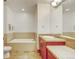 Bathroom featuring a soaking tub, tile flooring, cherry vanity with plenty of counter space and recessed lighting at 2958 Syracuse St # 204, Denver, CO 80238