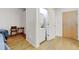 Bedroom view showcasing a washer/dryer closet and the entrance door at 2958 Syracuse St # 204, Denver, CO 80238