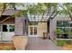 Inviting brick building entrance with a covered entryway and landscaping at 2958 Syracuse St # 204, Denver, CO 80238